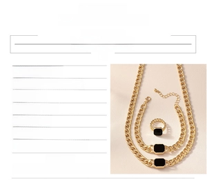 Macro detail of gold-plated geometric square chain necklace, bracelet and ring jewelry set