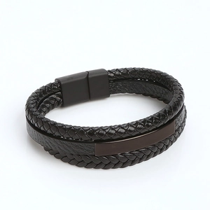 Detail of double-layer black braided leather bracelet with magnetic metal clasp