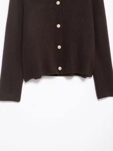 Detail of dark coffee knitted cardigan featuring embossed gold metal buttons and texture