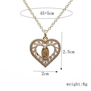 Close-up of gold heart pendant with Virgin Mary icon and zircon stones on white background