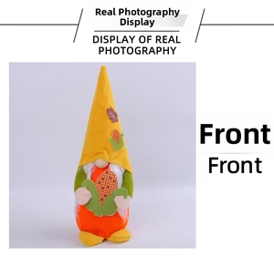 Front view of an autumn gnome plush featuring a maple leaf hat and holding corn