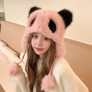 Close-up of pink panda plush trapper hat featuring soft faux fur and fluffy pom-pom ties