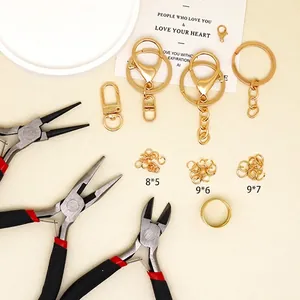 DIY keychain accessory kit with gold keyrings, lobster clasps, and crafting tools