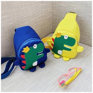 Close-up of cute cartoon dinosaur crossbody chest bags for kids in blue and yellow colors