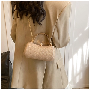 Detailed close-up of a golden glitter chain bag with rhinestone clasp for evening parties