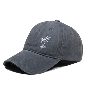 Detail of white palm tree embroidery on distressed grey washed cotton baseball cap