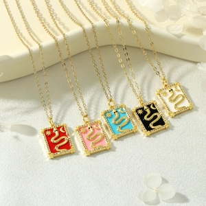 Detailed macro of 18k gold plated tarot necklaces with colorful enamel snake pendants