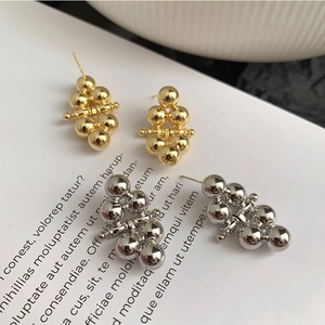 Elegant polished gold and silver ball stud earrings in a minimalist geometric stacked design