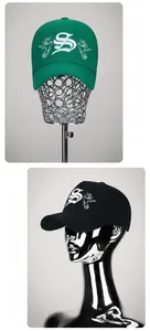 Detail of premium cotton baseball caps in green and black with white 3D bird embroidery