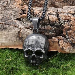 Retro stainless steel skull pendant necklace with beaded chain for men on natural wood