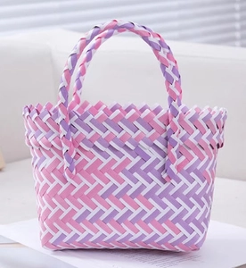Detailed close-up of handmade pink and purple woven gift basket with serrated edges