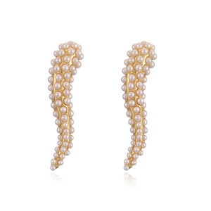 Detail of elegant gold-tone earrings featuring intricate white pearl pavé inlay design