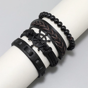 Detail of 4-piece vintage leather bracelet set with beads and metal rudder charm