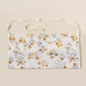 Detail view of the floral cotton baby organizer bag with soft muslin texture and ties