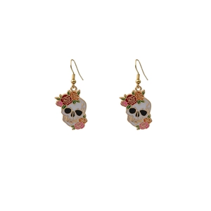Close-up of gothic skull earrings with rose floral design and colorful enamel finish