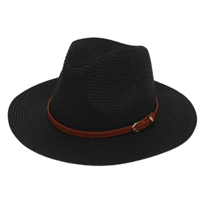 Detail of black straw Panama hat featuring a brown leather band and gold metal buckle