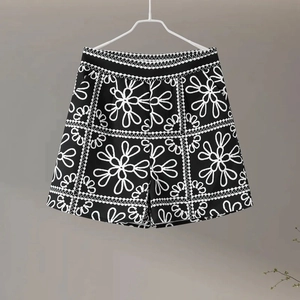 Detail of high-waisted black and white floral print shorts with elastic waistband