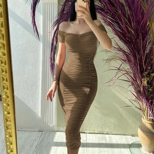 Close-up of the brown off-shoulder dress featuring high-stretch ruched fabric texture