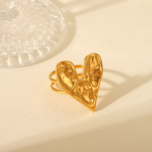 Detailed view of dual-band gold ring featuring a heart-shaped lava texture finish