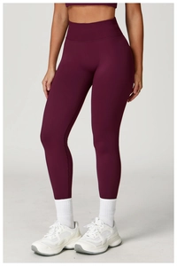 Detail of high-waisted seamless dark purple yoga leggings with supportive compression fabric