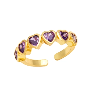 Gold open ring featuring multi-stone heart shaped purple zircons on a white background