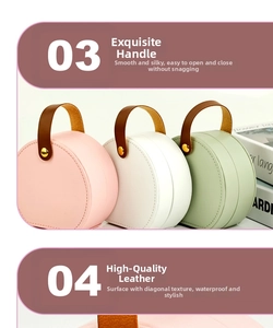 Detail view of portable leather jewelry boxes in pink, white, and green with easy-carry handles