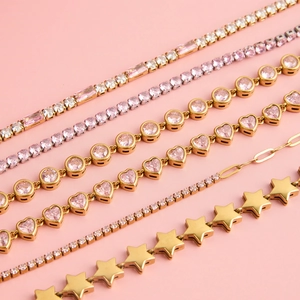 Detailed macro view of heart-shaped pink zircon and star pendants on gold jewelry sets