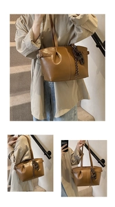 Detail view of brown pleated tote bag with metal side buckles and soft leather texture