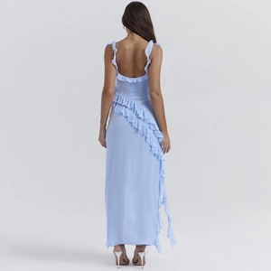 Detail of light blue open back dress featuring asymmetric ruffle trim and flowing fabric