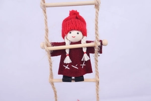 Detail of wool felt Christmas elf climbing a rope ladder with wooden rungs for decor