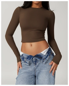 Close-up of brown cropped slim-fit long sleeve sports top with ribbed knit texture