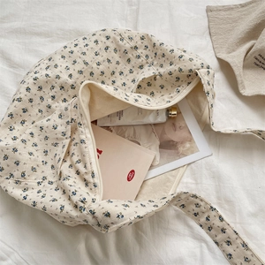 Detailed interior view of floral canvas tote bag showing large capacity and zipper closure