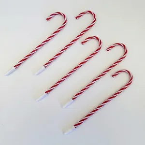 Close-up of five candy cane shaped ballpoint pens with red and white spiral stripes