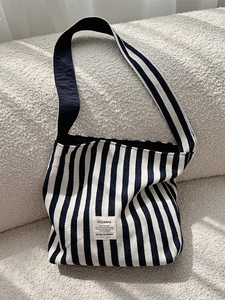Blue and white striped canvas tote bag with wide shoulder straps for daily use