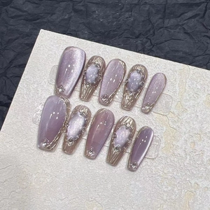 Cat eye lavender purple press-on nails with gold chrome texture and crystal accents