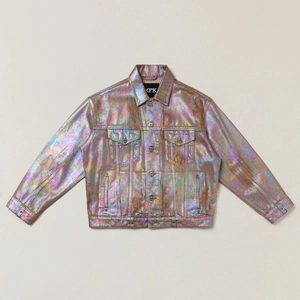 Macro shot of iridescent laser coating and metallic texture on a denim style jacket