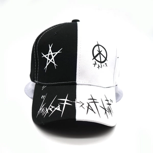 Detail of street graffiti print on black and white star patterned baseball cap brim