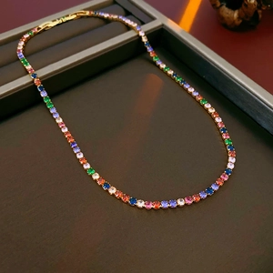 Detailed close-up of a gold-plated tennis necklace with colorful round zirconia stones