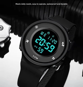 Macro detail of waterproof 5ATM digital sports watch with flexible black silicone strap