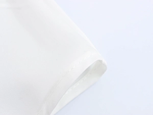 Macro close-up showing the smooth white fabric texture and precision stitching of the garment