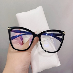 Close-up of black cat-eye glasses with blue light coating and white leather pouch
