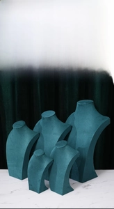Set of five teal velvet mannequin busts in tiered heights for elegant necklace display