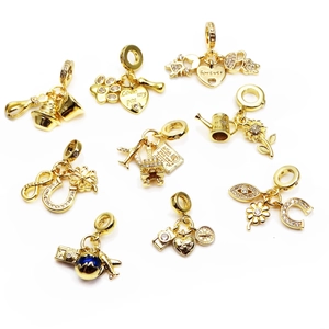 Set of gold-plated micro-pave zircon charms including heart, bell, and Eiffel Tower motifs
