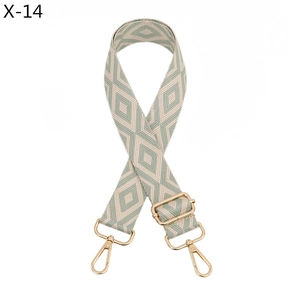 Detail of adjustable rhombus pattern strap with light gold metal swivel hooks and buckle