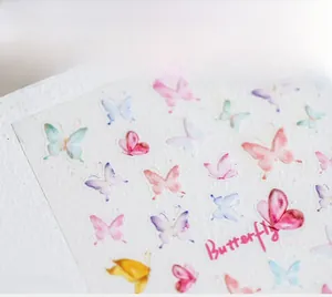 Macro shot of watercolor 5D butterfly nail art stickers with delicate hand-drawn patterns