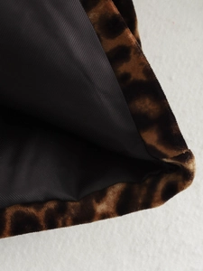 Close-up of leopard print brown suede fabric with black lining detail for women's blazer