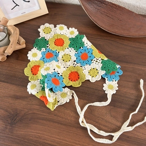 Detail showing colorful handmade crochet floral headscarf with intricate knit stitches