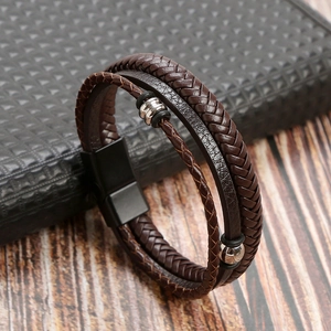 Macro shot of dark brown multi-layer braided leather bracelet with silver metal beads