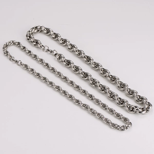Detailed macro view of two silver twisted rope chains in different thicknesses with lobster clasps