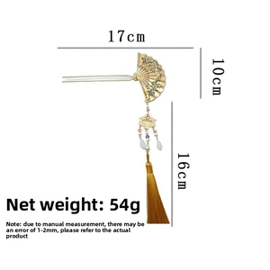 Detail of gold fan hair pin with white pearls and long tassels showing dimensions